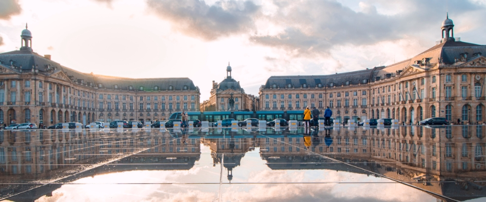 Neoclassical limestone buildings surrounding the Place de la Bourse in Bordeaux.